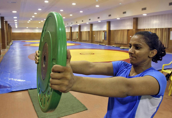 As Geeta Phogat completes her sprint at a sprawling sports campus in Punjab state, one of her coaches nods approvingly at her stopwatch, another rushes to check her pulse, and a third ushers her toward the gym for a bout of wrestling. Grappling with gender bias, Geeta heads to London