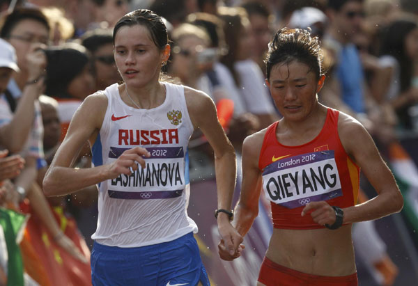 China's Choeyang Kyi (R) and Russia's Elena Lashmanova compete in the women's 20km race walk final at the London 2012 Olympic Games at The Mall August 11, 2012. China cheers for 1st Tibetan Olympic medalist