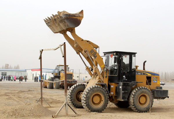 A man learns to drive a forklift truck during a training session in Hami, March 11, 2013. New skills for better jobs in Xinjiang