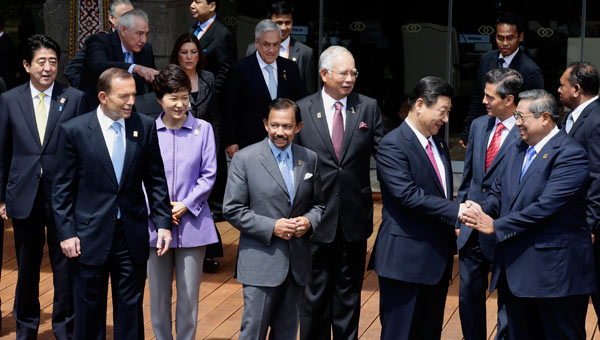 President Xi Jinping and his Indonesian counterpart Susilo Bambang Yudhoyono exchange greetings as they join other APEC leaders for a group photo in Bali, Indonesia, on Tuesday. Dennis Sabangan / Agence France-Presse President Xi calls for more APEC connectivity