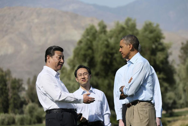 US President Barack Obama and Chinese President Xi Jinping talk as they tour the grounds at The Annenberg Retreat at Sunnylands in Rancho Mirage, California June 8, 2013. Obama and Xi start talk with a walk