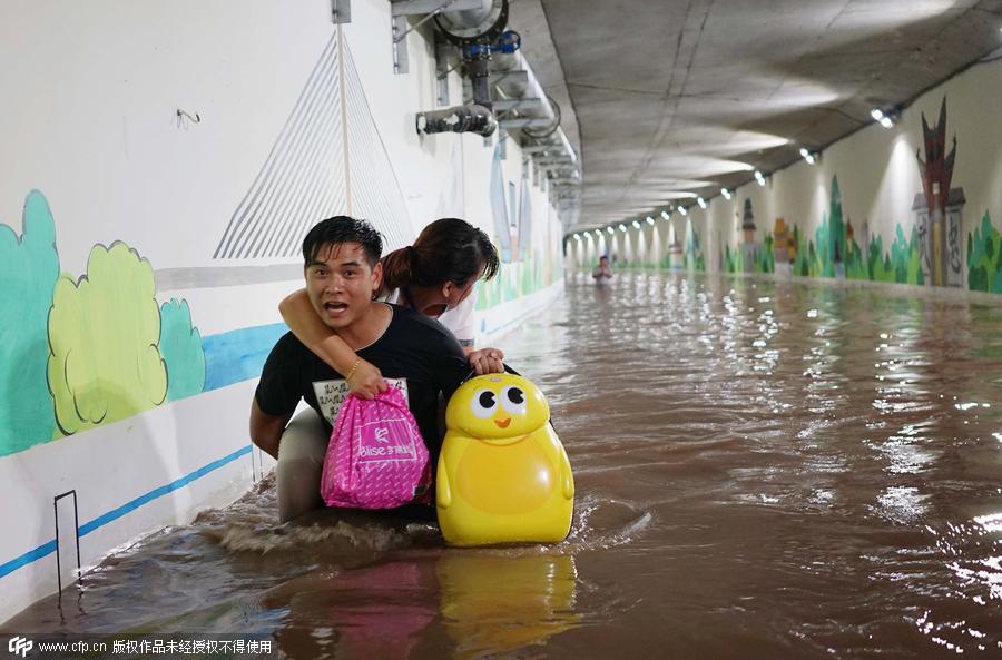 Family wades across flood to catch train
