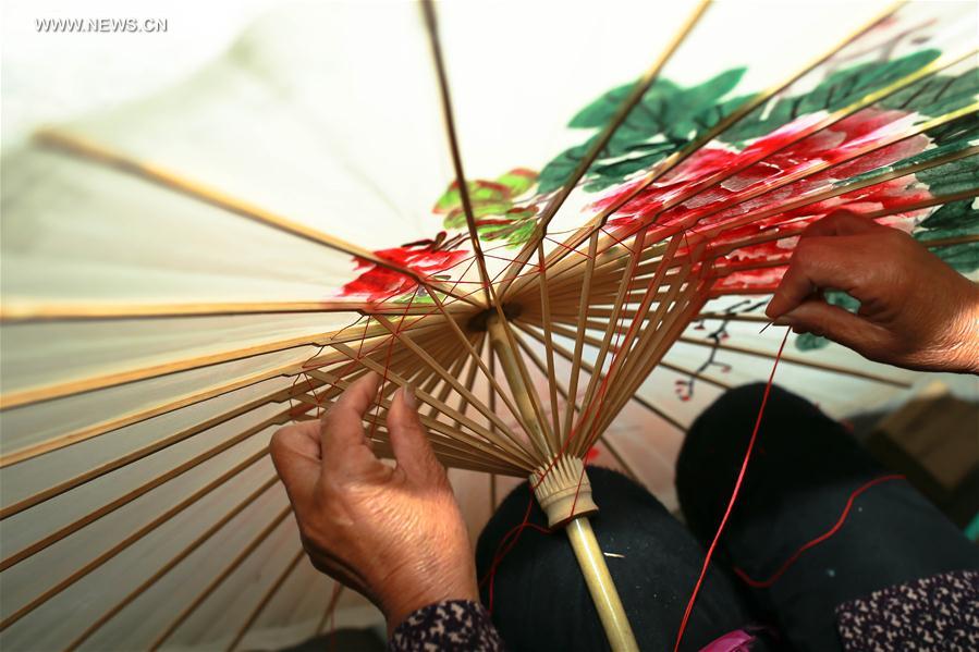 Traditional techniques of making Jialu oilpaper umbrellas in E China