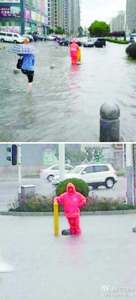南京“人肉窨井防護樁”成暴雨中最美風景