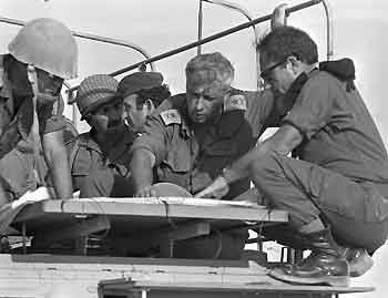 Then-Israeli Major General in the Reserves Ariel Sharon (2nd R) confers with comrades during the 1973 Middle East War in the Sinai Peninsula, October 10, 1973 in this handout photo released by the Government Press Office.