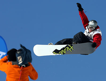 A cameraman films Germany's Jan Michelis (R) during the men's Halfpipe final of the Snowboard World Cup contest in Leysin, Switzerland, January 19, 2006. Michaelis took third place behind second placed Therry Brunner of Switzerland and winner Halvor Lunn of Norway. [Reuters]