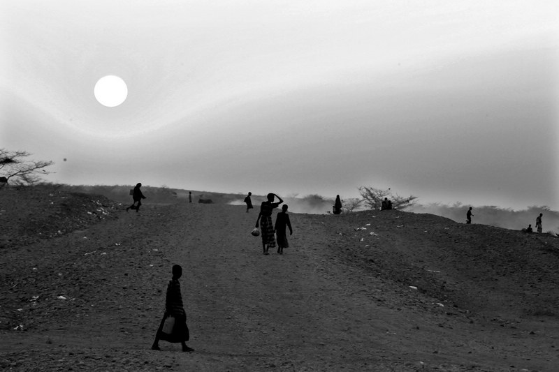 Somali refugees at the Transit Center on their way back to their tents after collecting food and water. The world in photos: Somali refugees