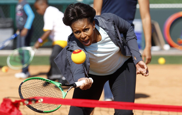 US first lady Michelle Obama plays mini-tennis during a 'Let's Move!' faith and communities physical activity at Disney World's ESPN Wide World of Sports in Orlando, Florida. 'Let's Move' with US first lady