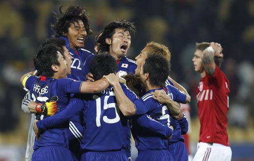Japan reach last 16 with win over Denmark