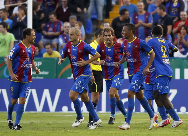 Levante's players celebrate after they scored against Malaga during their Spanish first division soccer match at the Ciudad de Valencia Stadium in Valencia Oct 16, 2011. Levante living the dream after humbling Malaga