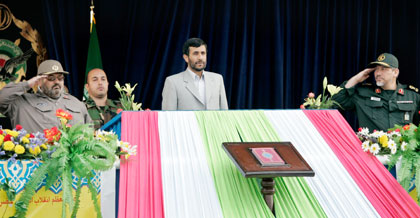 Iranian President Mahmoud Ahmadinejad (C) reviews a military parade flanked by Revolutionary Guards Commander Rahim Safavi (R) and General Hassan Firoozabadi (L), Chief of Staff of Iranian Armed forces, in Tehran April 18, 2006. Ahmadinejad said during an armed forces parade on Tuesday that any aggressor would regret attacking the Islamic Republic, which is embroiled in a nuclear dispute with the West. 