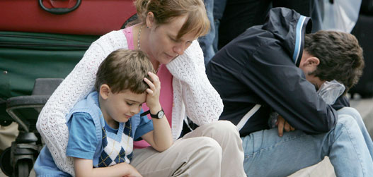 Passengers wait for delayed flights outside terminal one of Heathrow airport in London August 12, 2006. The British government on Saturday rejected as "dangerous and foolish" accusations that its foreign policy heightened the threat of terror attacks after police foiled a plot to blow up transatlantic airliners. 