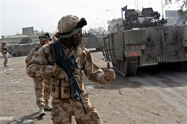 British army soldiers take defensive positions after their convoy was struck by a roadside bomb in Basra, 550 kilometers (340 miles) southeast of Baghdad, Iraq, Saturday, Jan. 6, 2007. A roadside bomb targeted a British army convoy and wounded one soldier, whose wounds were not considered to be life-threatening, the British army said. (AP Photo/Nabil al-Jurani)
