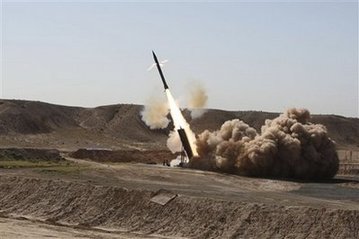 Under pressure for nukes, Iran test fires missiles