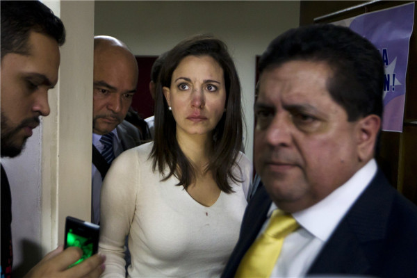 Venezuelan opposition lawmaker Maria Corina Machado (center) arrives at a news conference after a fight broke out at a session of the National Assembly in Caracas on Tuesday. Punch-up in Venezuela parliament